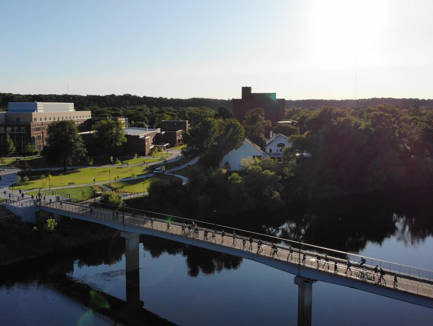 calm river aerial view of footbridge 