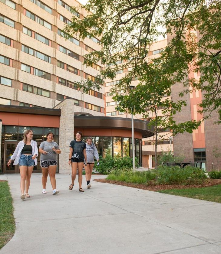 four students walking out of Towers 